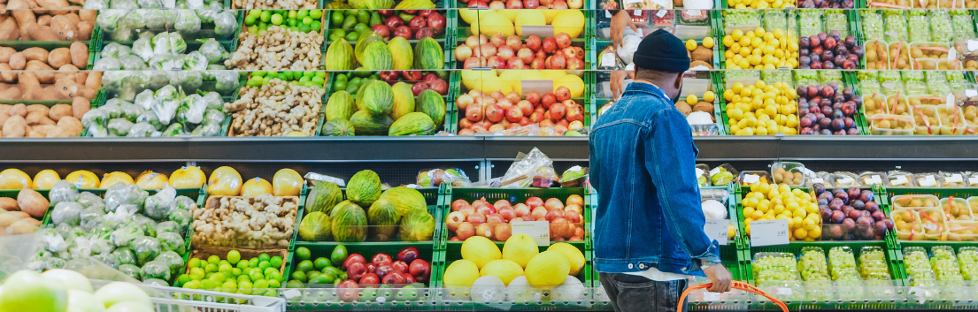 Product-Recall-Header-v3 Back view of a man standing in produce aisle holding a basket