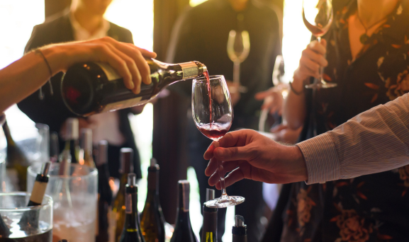 Rural-Property-Hospitality Close up of someone pouring wine into a glass